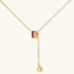 Three-piece jewelry set featuring 14K gold plated pieces with deep red cubic zirconia stones and clear crystals on cream background.